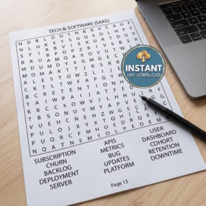 The page from a business and money word search book titled Tech & Software (SAAS) laying on a desk with a pen next to a laptop.